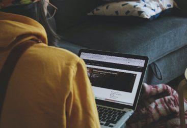 female developer wearing a yellow hoodie looking at a recipe website